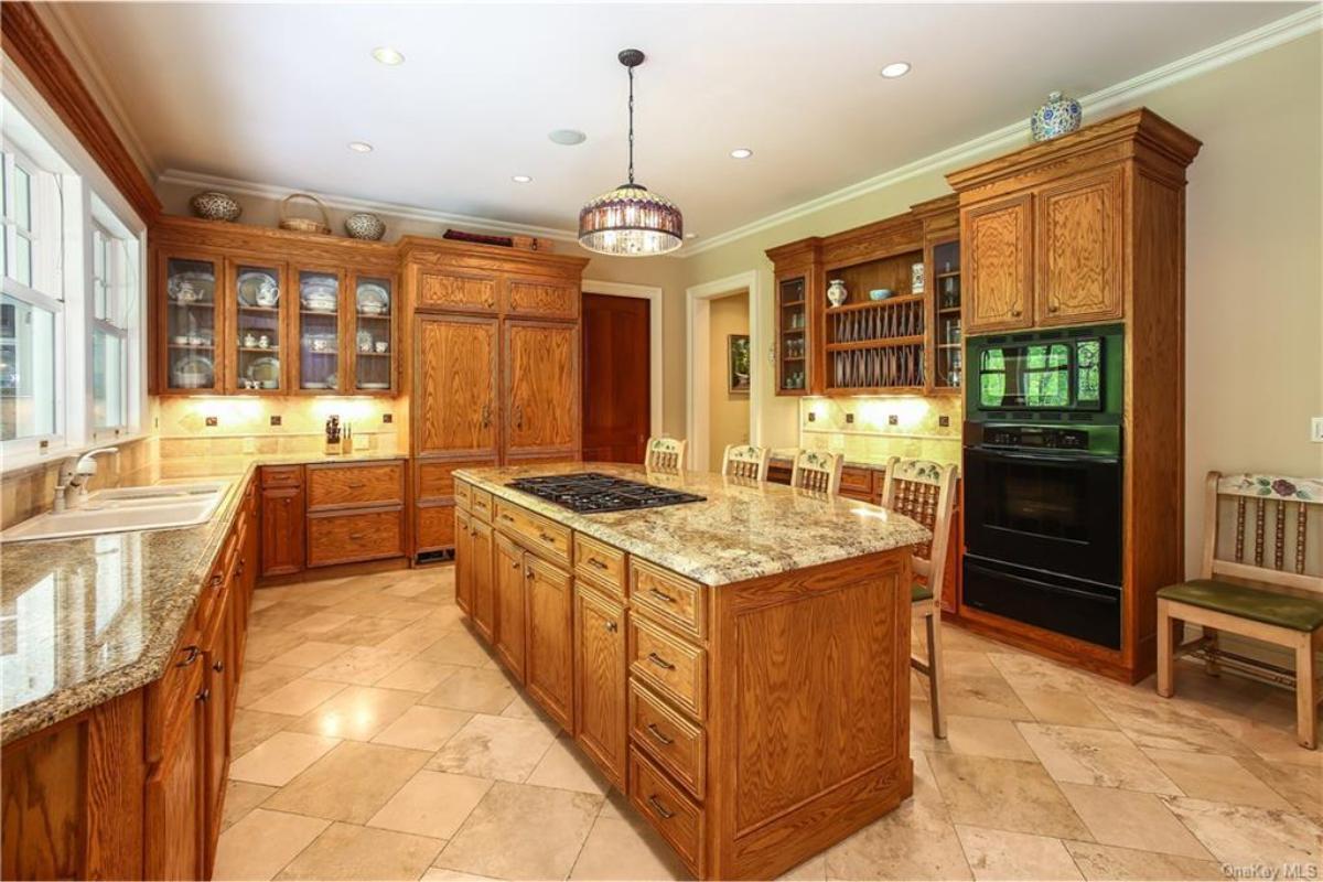 Explore This Craftsman Kitchen with Rich Wood Cabinetry and Granite Island