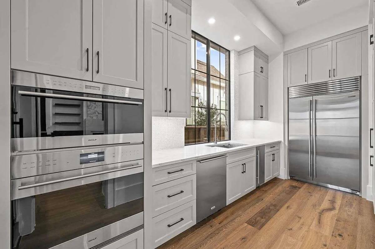 Wow, Notice the Sleek Double Ovens and Expansive Windows in This Culinary Space