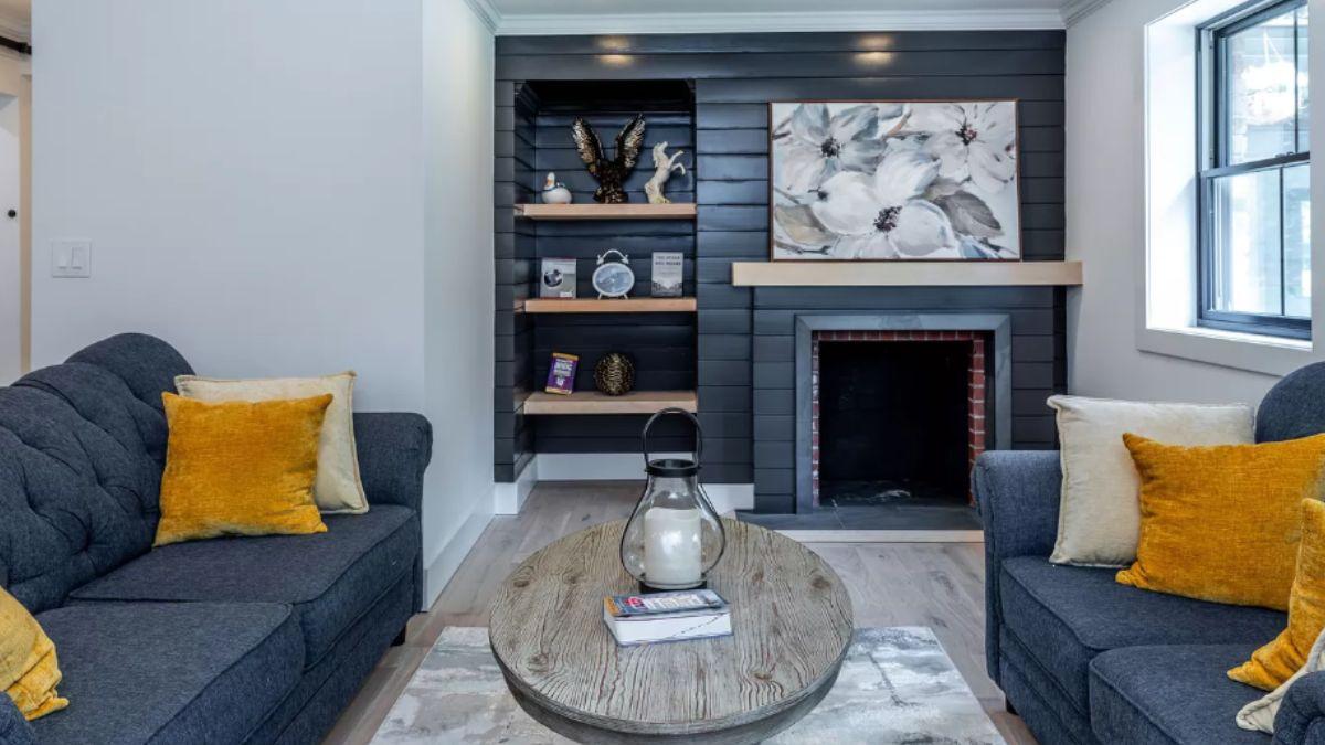 Notice the Charcoal Shiplap Wall and Cozy Fireplace in This Charming Living Room
