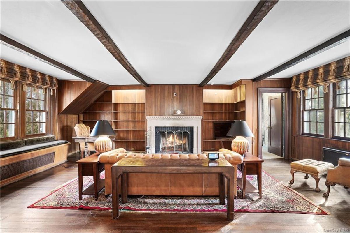 Warm Wooded Study with Classic Beamed Ceiling and Cozy Fireplace