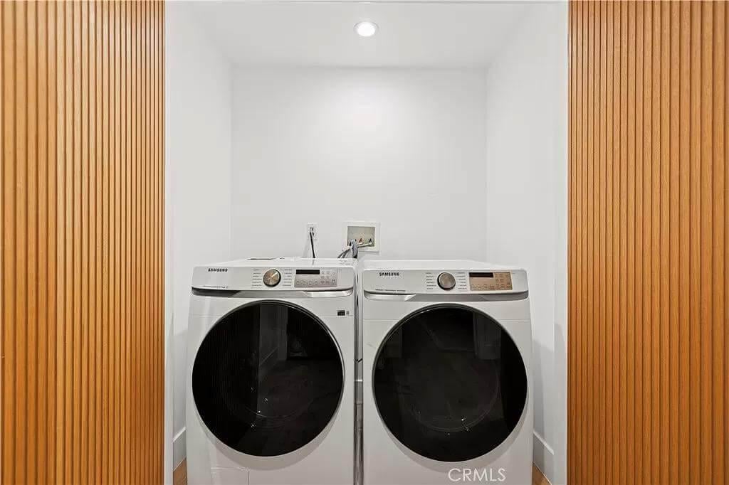 Sleek Laundry Nook with Vertical Wood Paneling