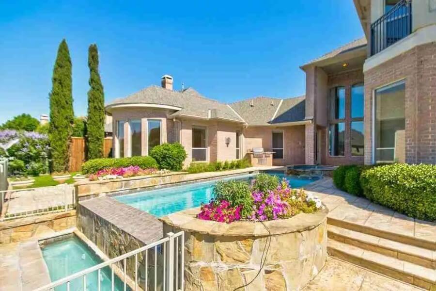 Enjoy the Multi-Level Pool and Stone Terrace in This Outdoor Haven