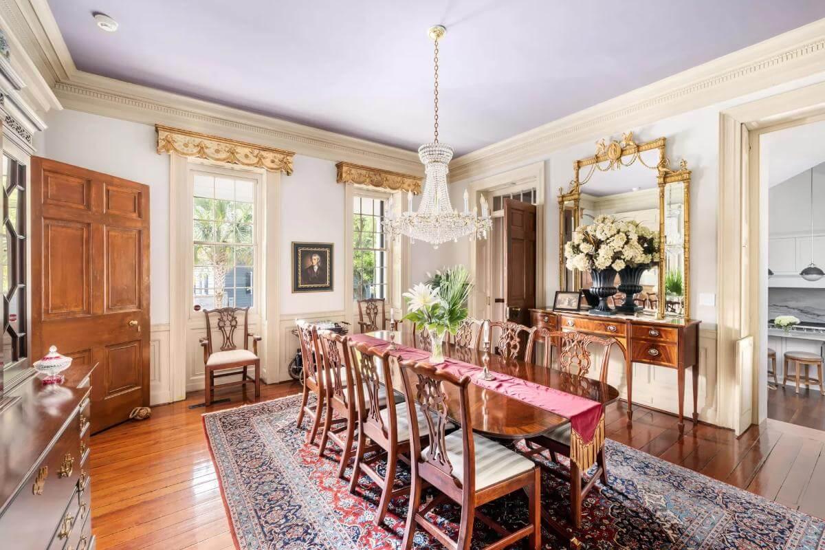 Regal Dining Room with Elegant Chandelier and Antique Mirror