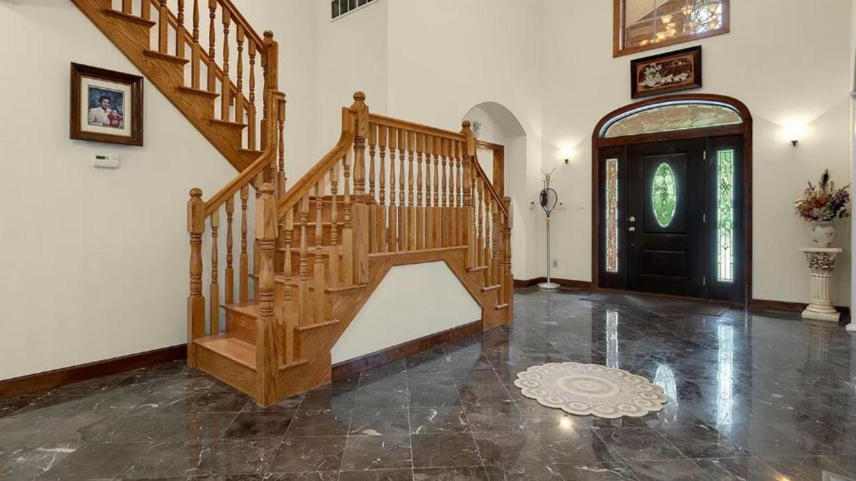 Grand Entry with Curved Staircase and Marble Flooring