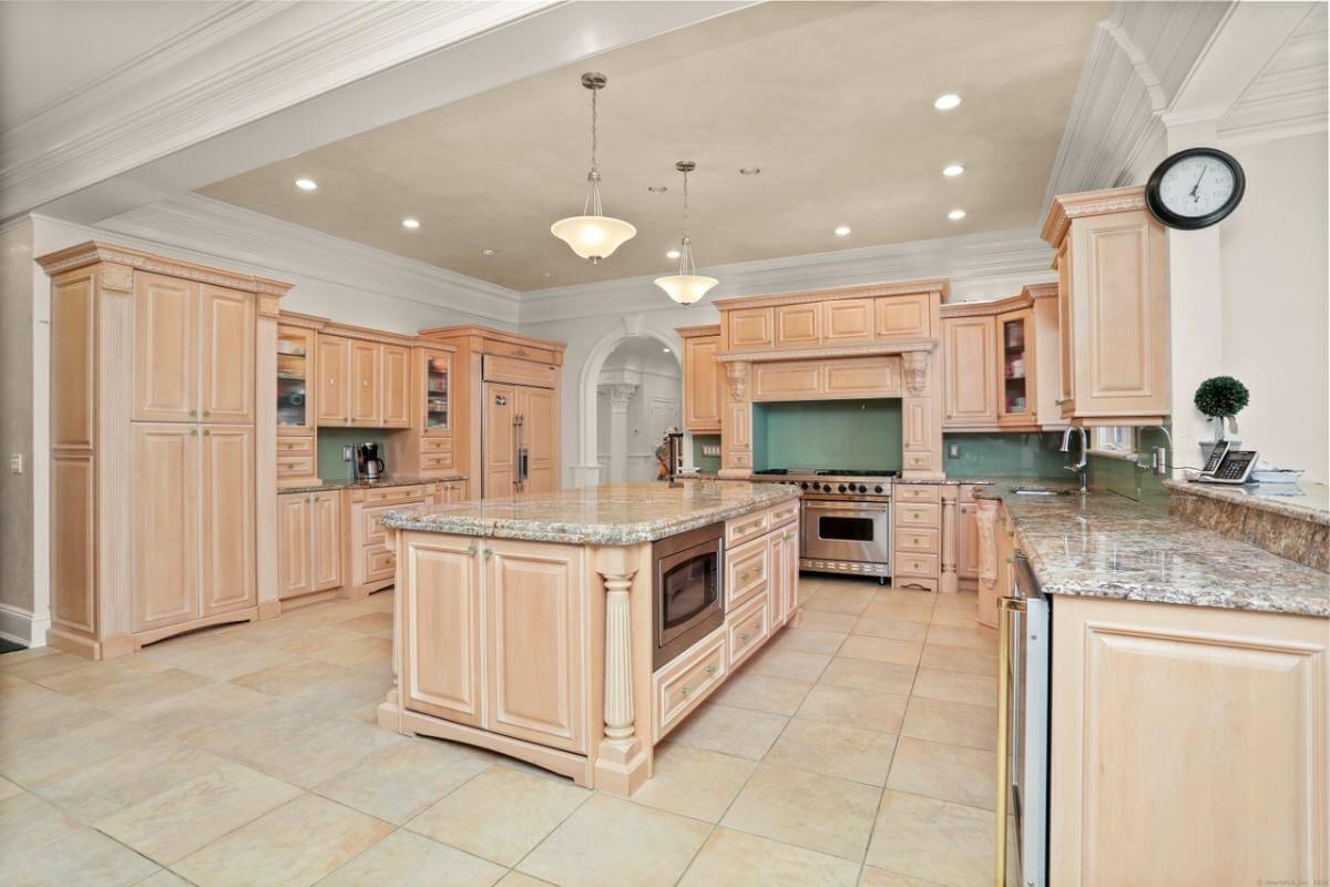 Check Out This Kitchen with Its Eye-Catching Marble Island and Classic Cabinetry