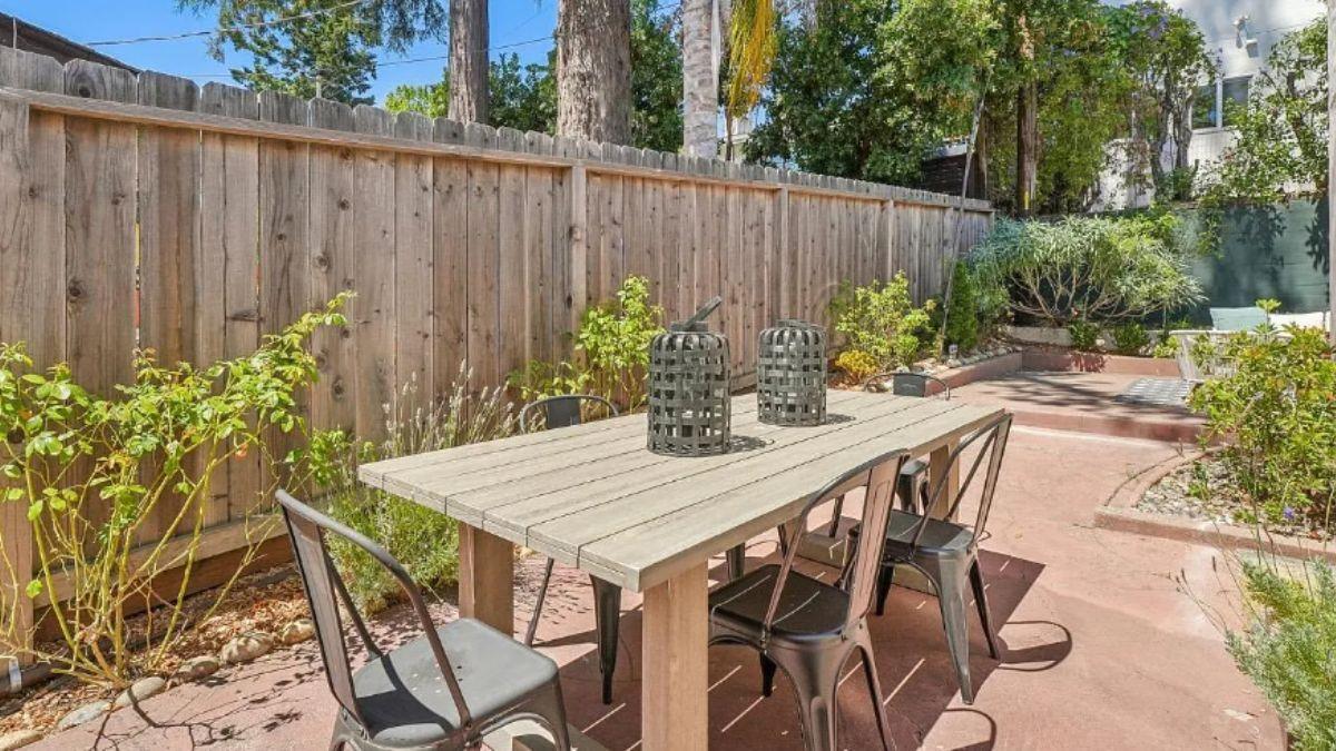 Outdoor Dining Space with Rustic Table and Metal Chairs