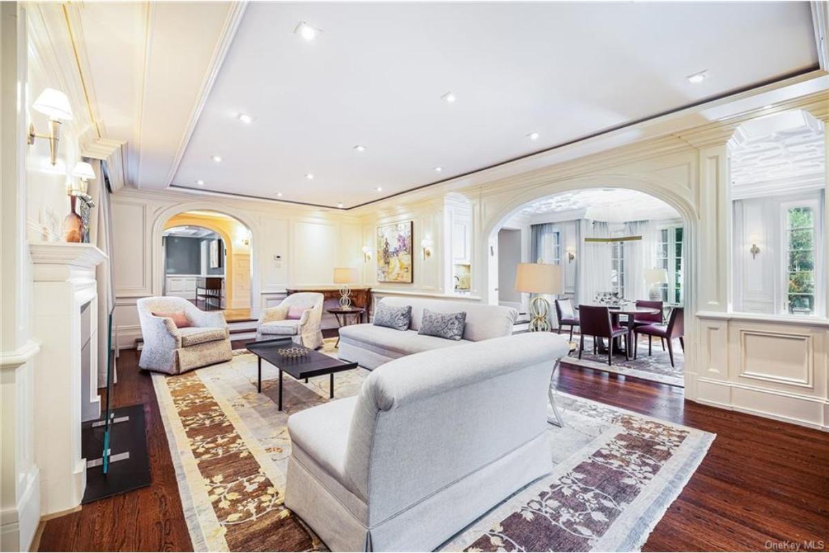 Elegant Living Room with Arched Doorways and Detailed Crown Molding