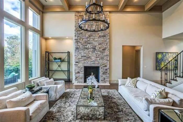 Spacious Living Room Featuring a Towering Stone Fireplace