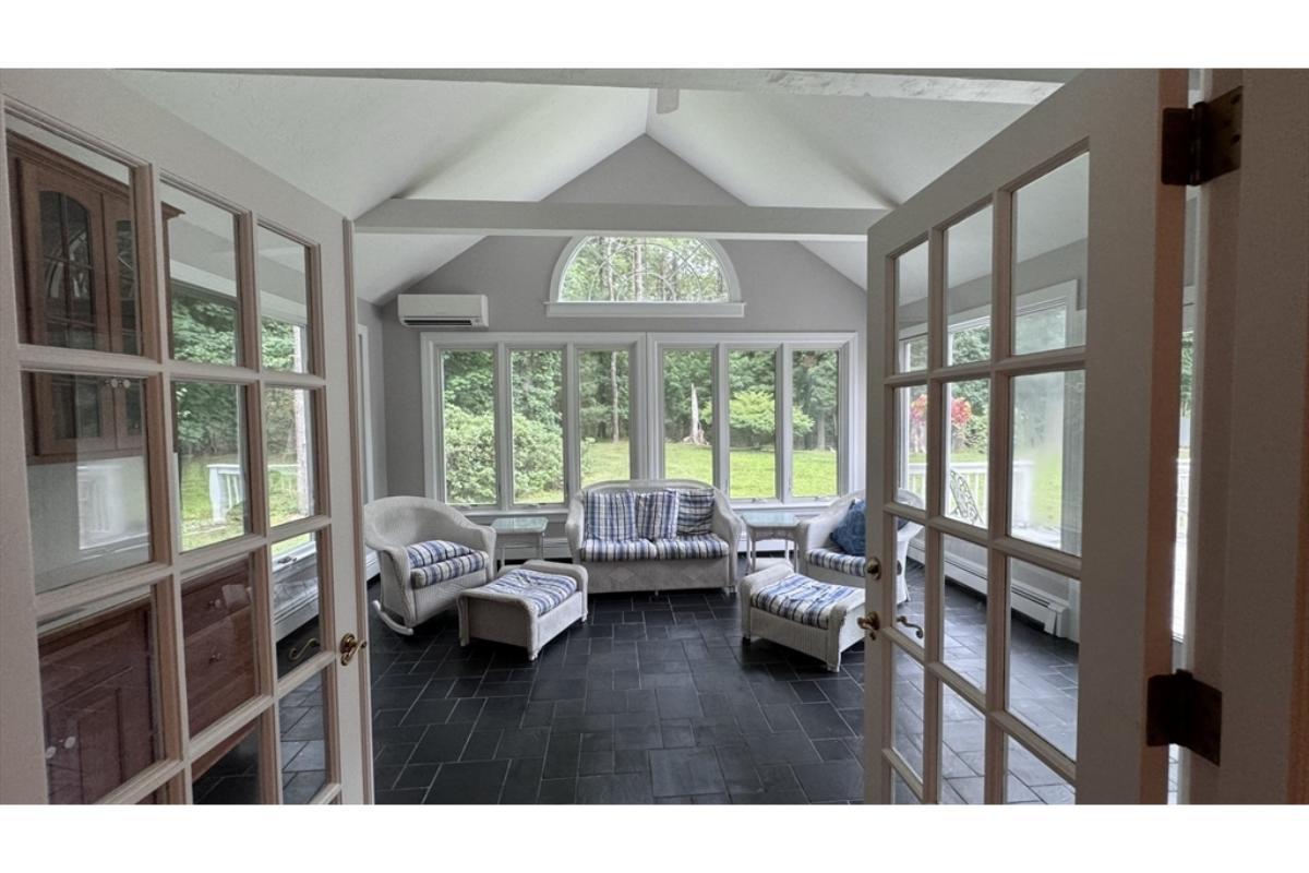 Step Into the Sunlit Solarium with Vaulted Ceiling and Slate Floors