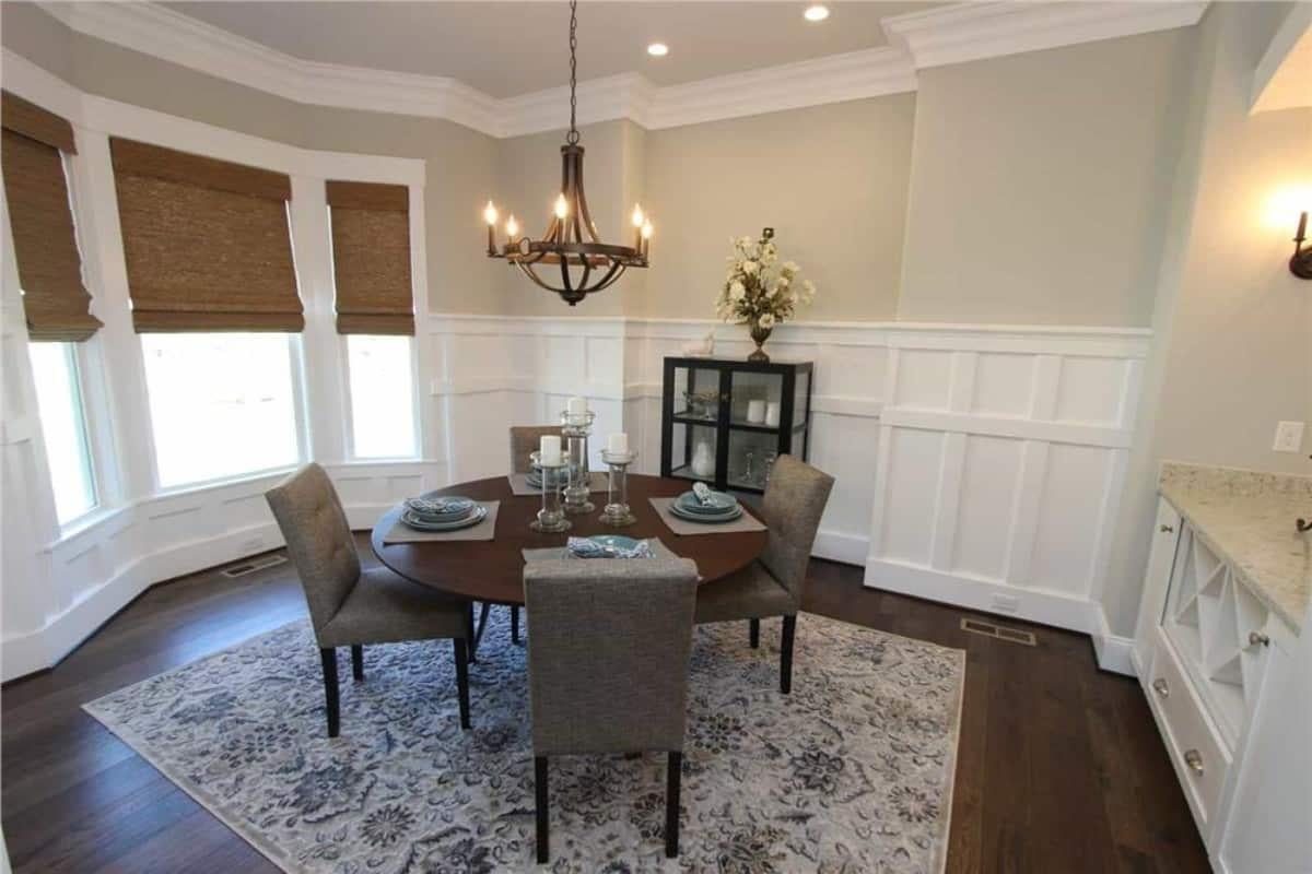 Elegant Dining Room with Craftsman Wainscoting and a Stylish Chandelier
