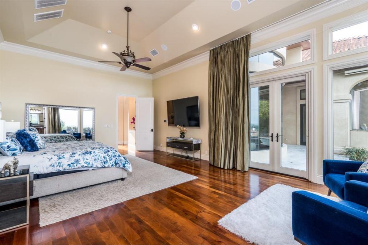 Spacious Master Bedroom with Rich Hardwood Flooring and Access to Outdoor Retreat