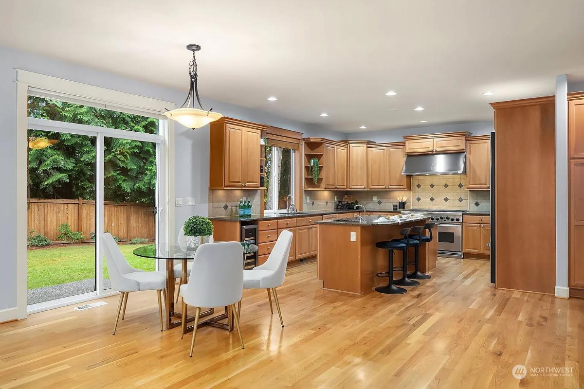 Spacious Craftsman Kitchen with Light Wood Cabinetry and Garden Views