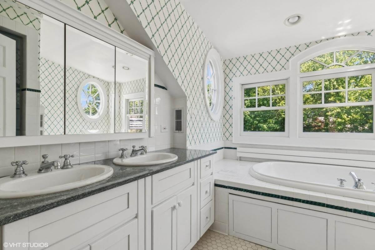 Bright Bathroom with Oval Window and Dual Sinks for Daily Ease