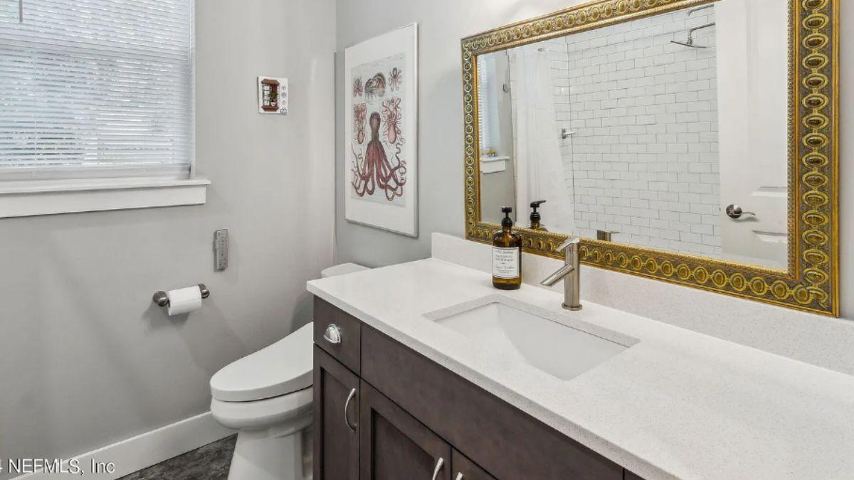 Look at This Bathroom with its Statement Gold Mirror