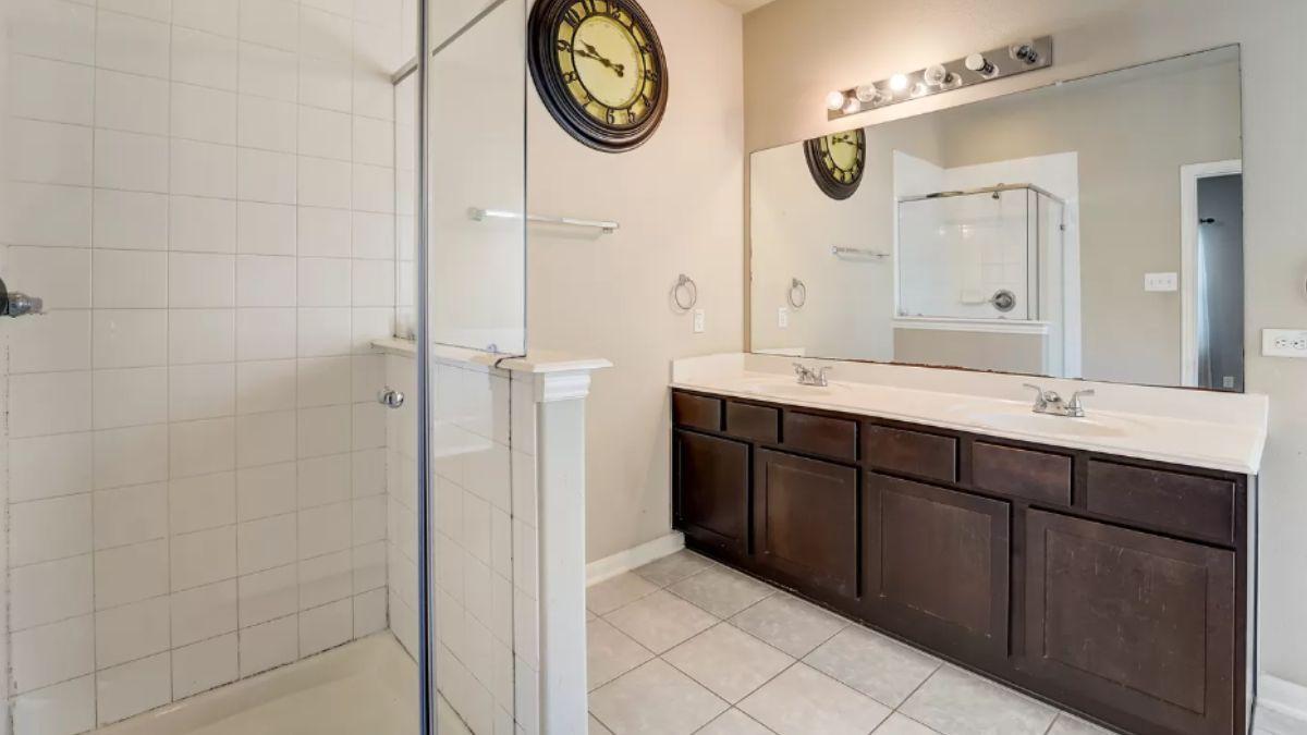 Streamlined Bathroom with Double Vanity and Oversized Clock
