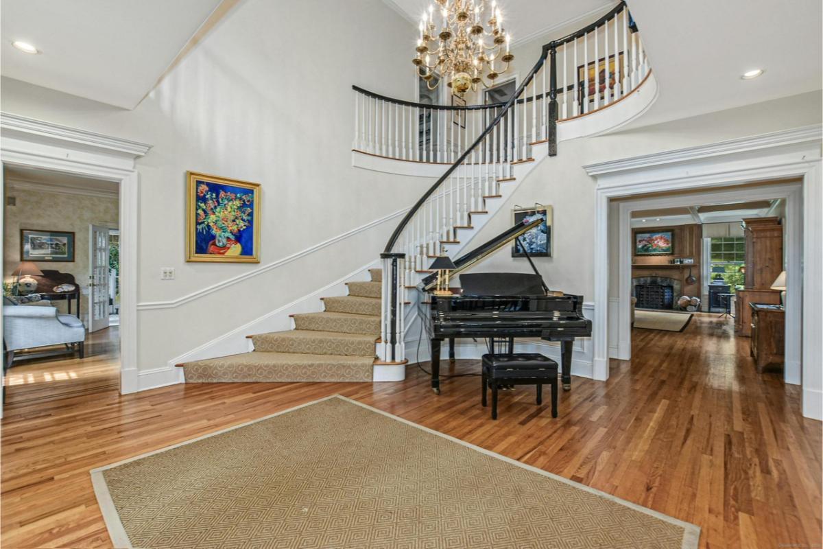 Wow, Look at the Graceful Curved Staircase and Grand Piano in This Elegant Foyer