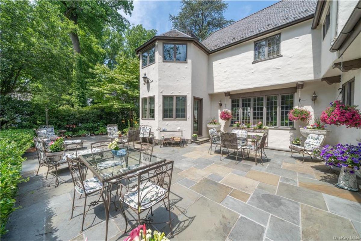 Garden Oasis with a Tudor Touch: Notice the Unique Stone Patio Layout
