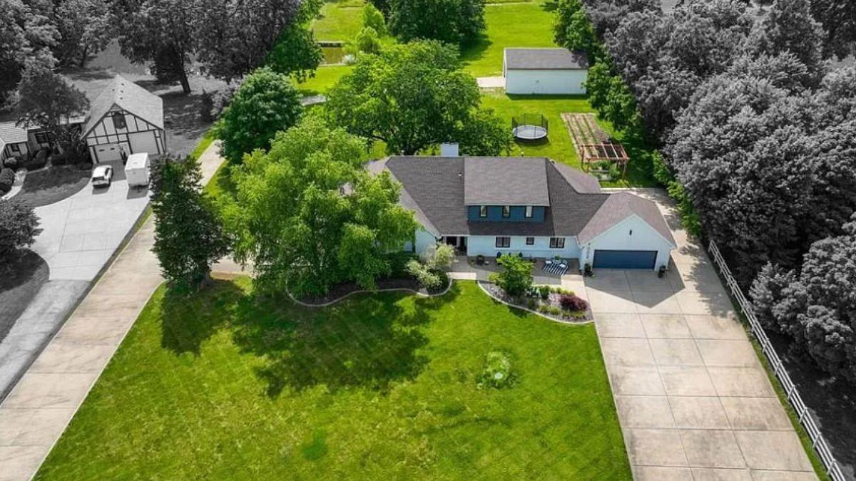 Aerial View Capturing Expansive Grounds and Modern Farmhouse Design