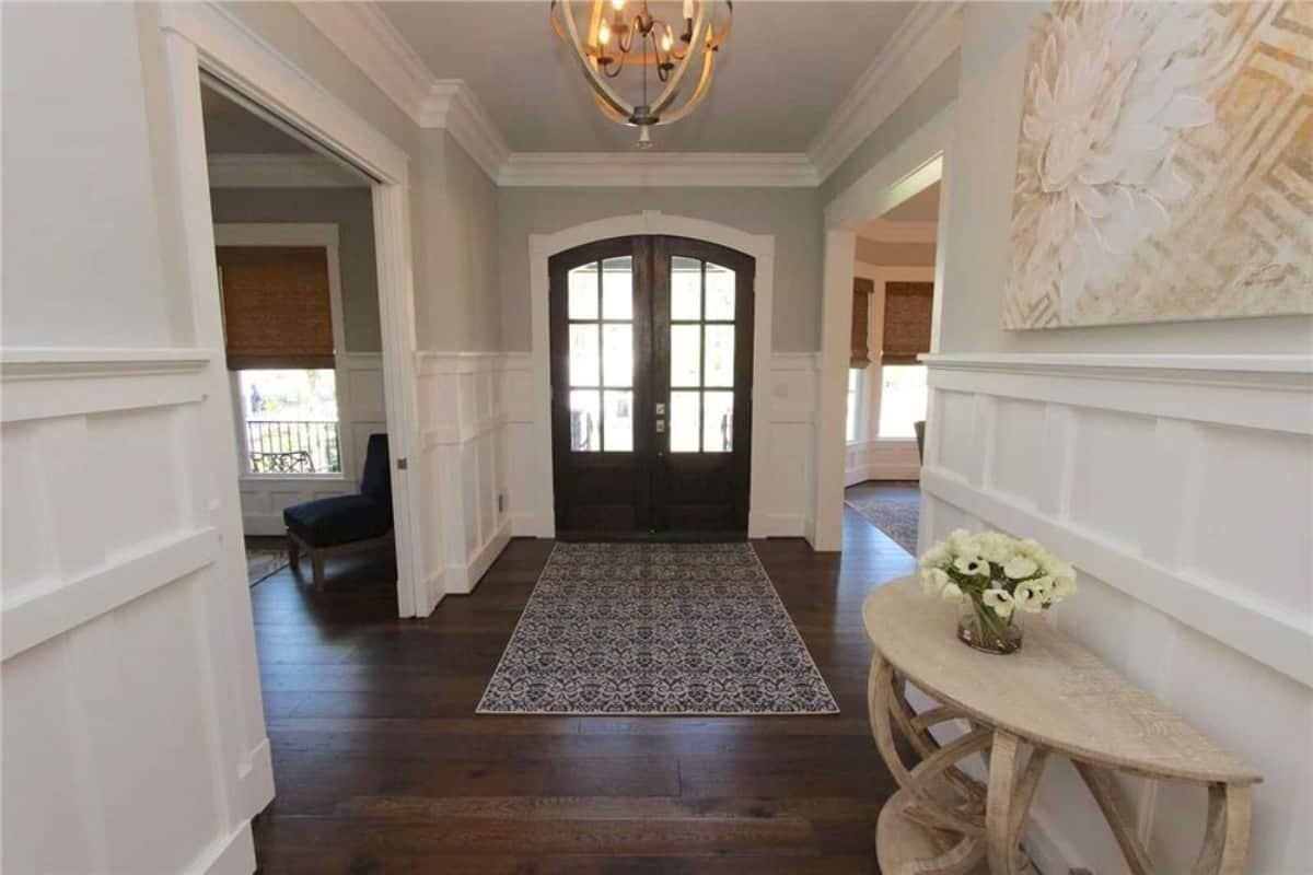 Welcoming Entryway with Elegant Double Doors and Detailed Wainscoting