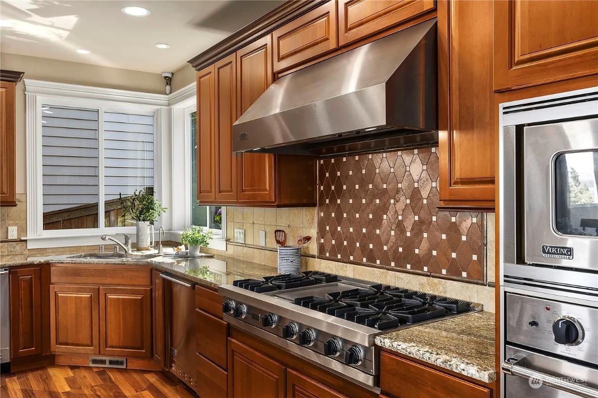 Rich Wood Cabinets and Geometric Backsplash in the Kitchen
