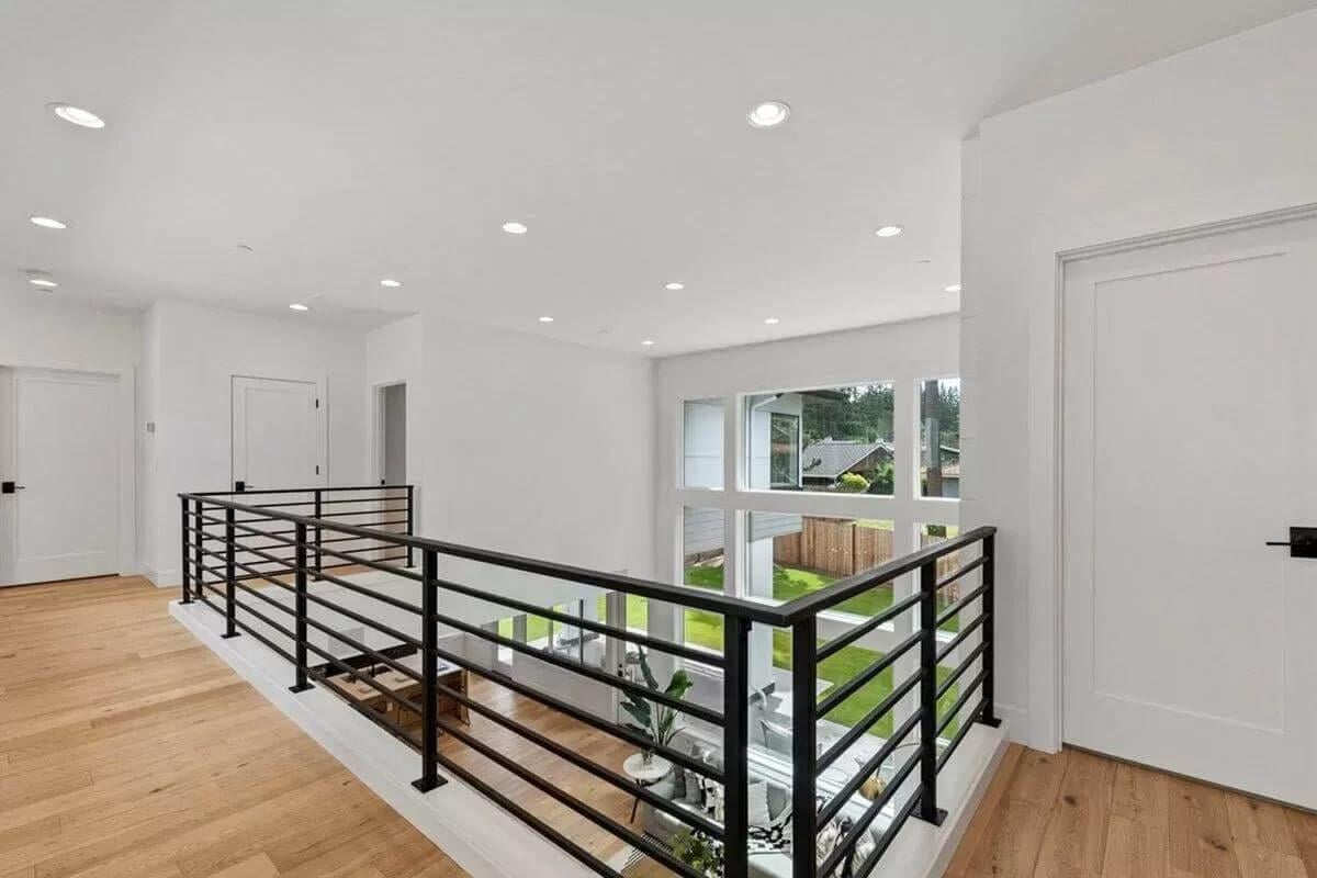 Notice the Crisp Black Railings That Define This Bright Upper Landing
