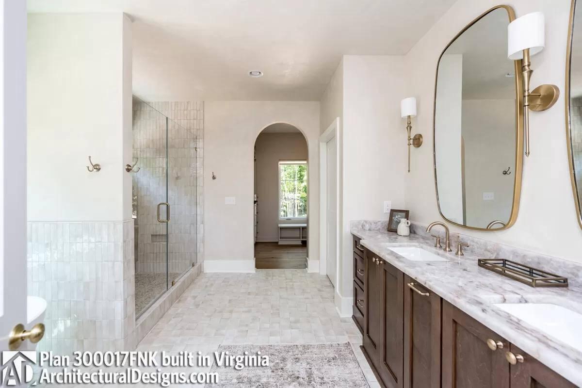 This Bathroom Impresses with an Arched Entry and Timeless Double Vanity