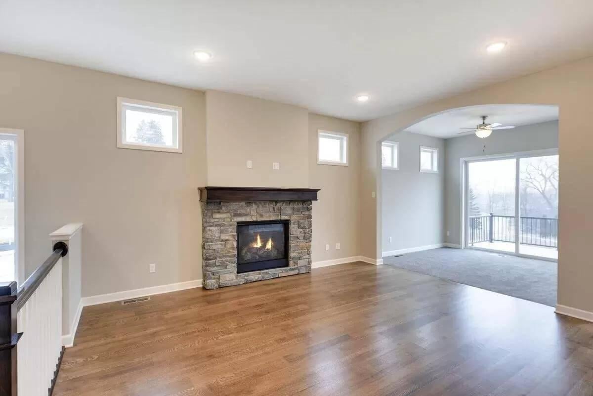 Admire the Robust Stone Fireplace and Open Transition to the Balcony