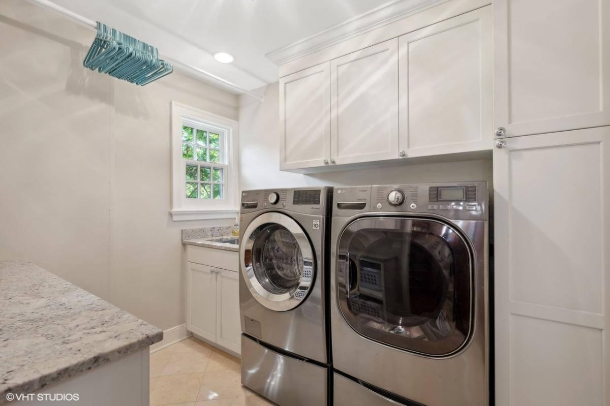 Spot the Practical Hanging Rod in This Efficient Laundry Room
