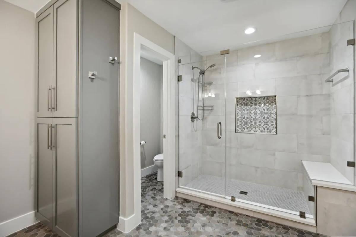 Sleek Bathroom with a Stylish Hexagonal Tile Floor and Glass Shower