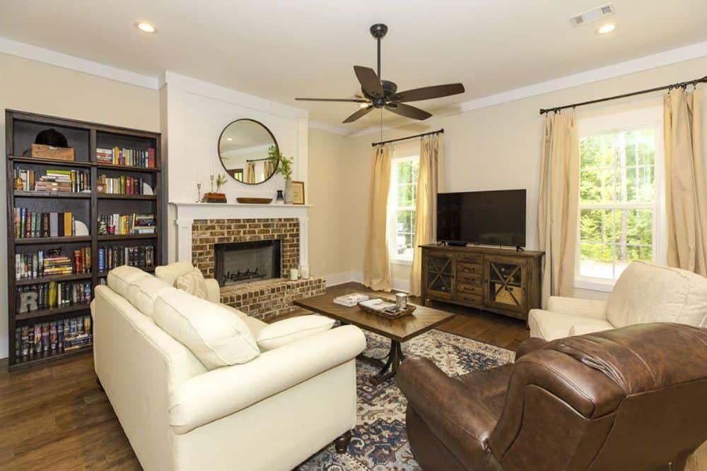 Charming Craftsman Living Room with Brick Fireplace and Built-In Bookshelves