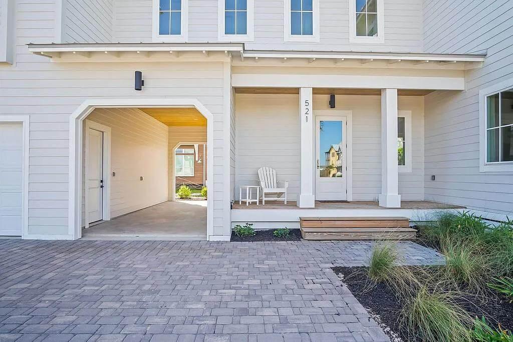 Inviting Porch with a Simple White Chair and Brick Detailing