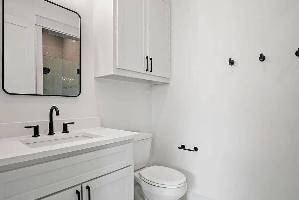 Modern Touch with Matte Black Accents in This Sleek Powder Room