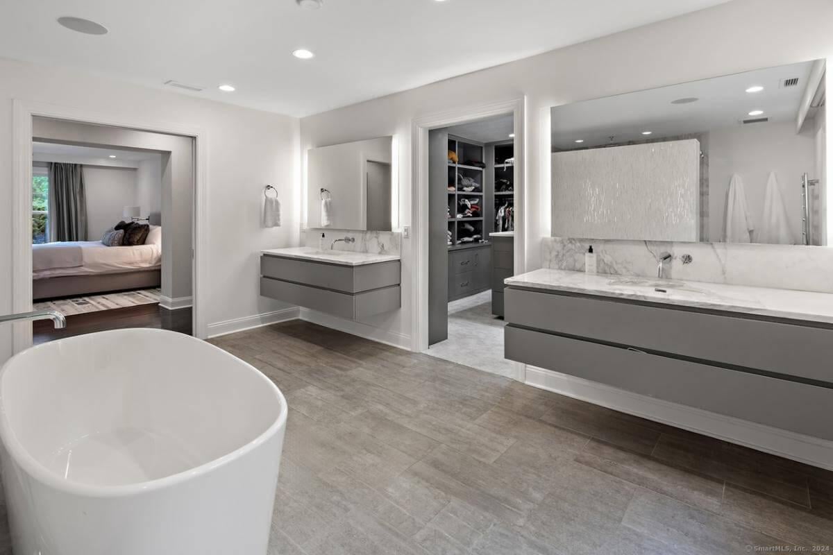 Explore This Serene Bathroom with a Freestanding Tub and Modern Vanities