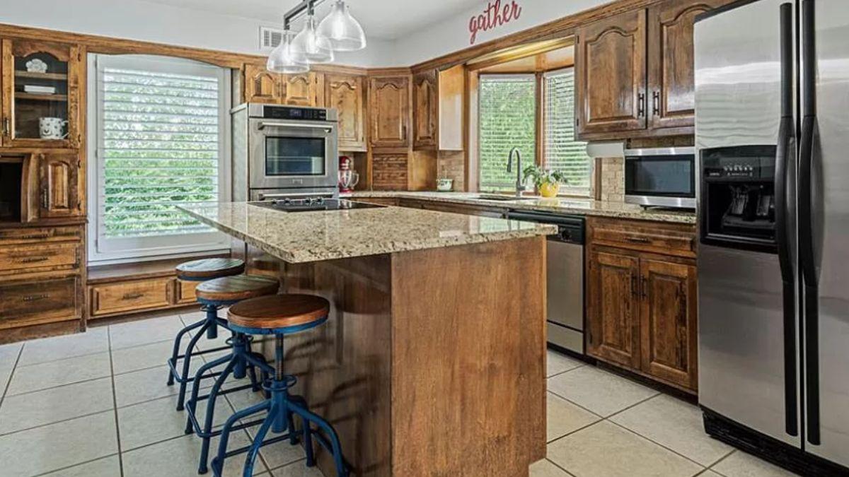 Explore This Warm Kitchen with Sturdy Wooden Cabinets and a Central Island