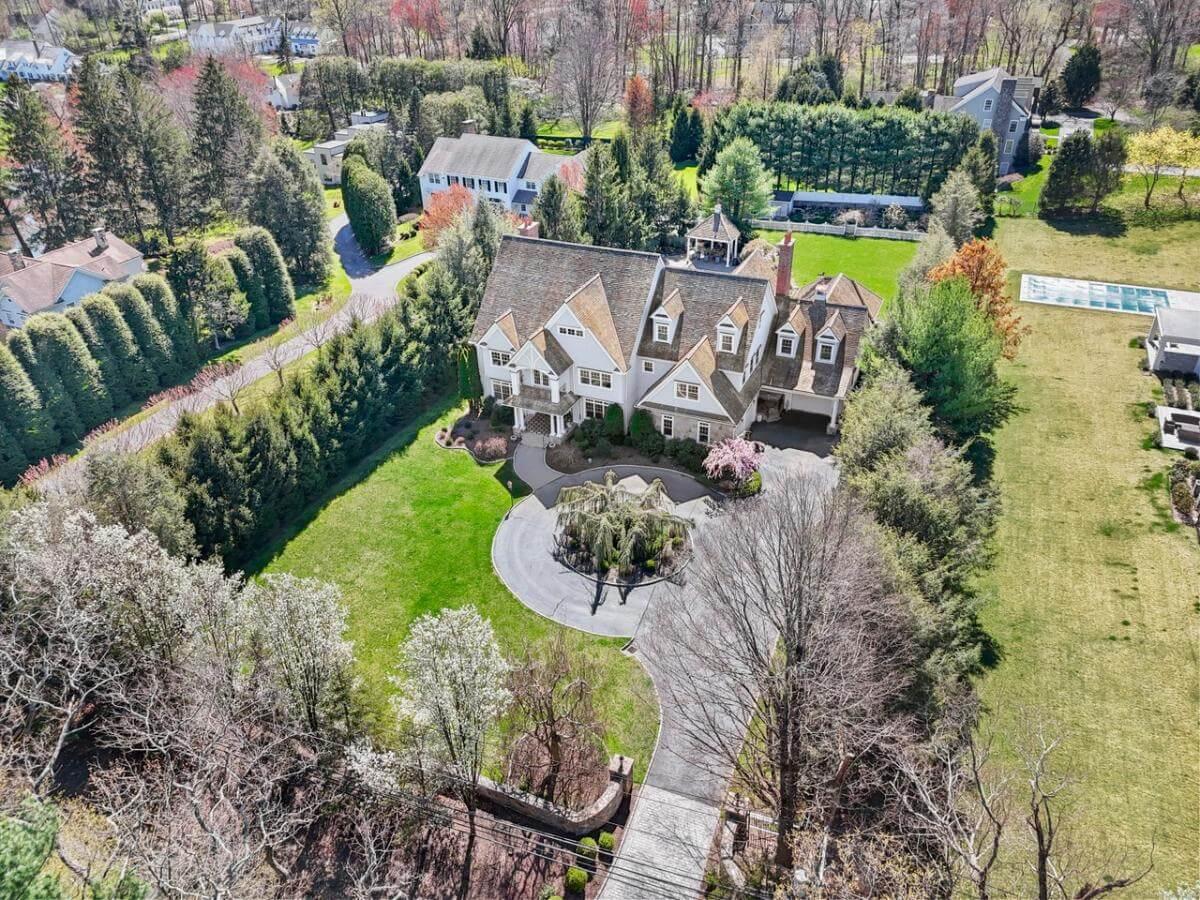 Aerial View of a Grand Estate with Manicured Grounds and Circular Driveway