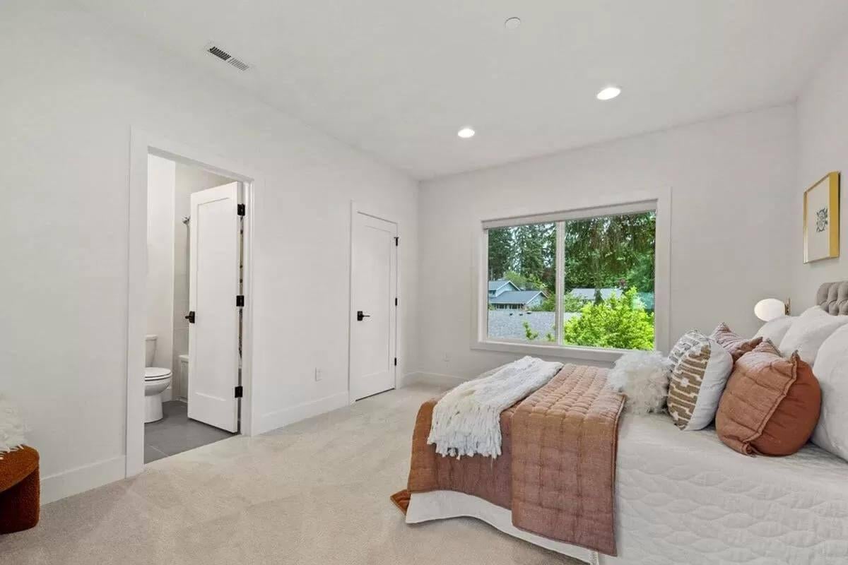 Simple Bedroom Design with Large Window and Plush Bedding