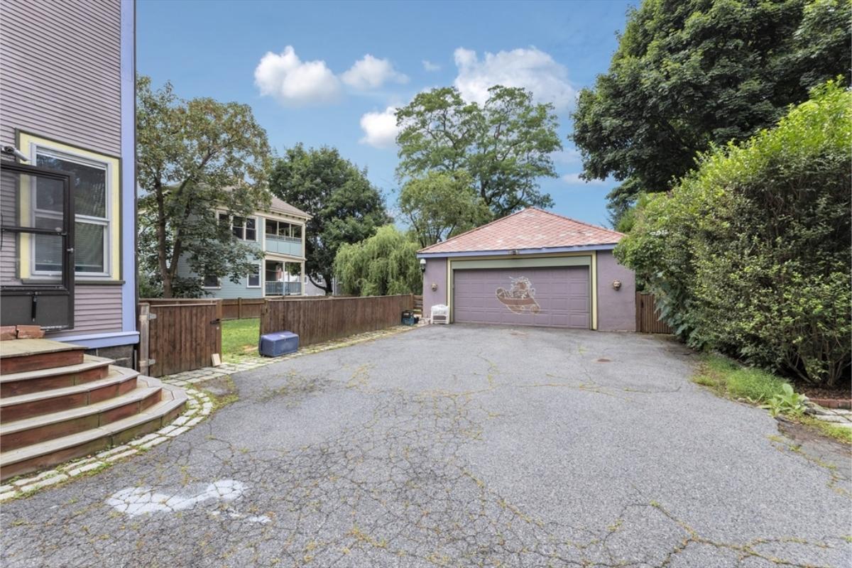 Charming Garage with Unique Artwork and Ample Driveway Space