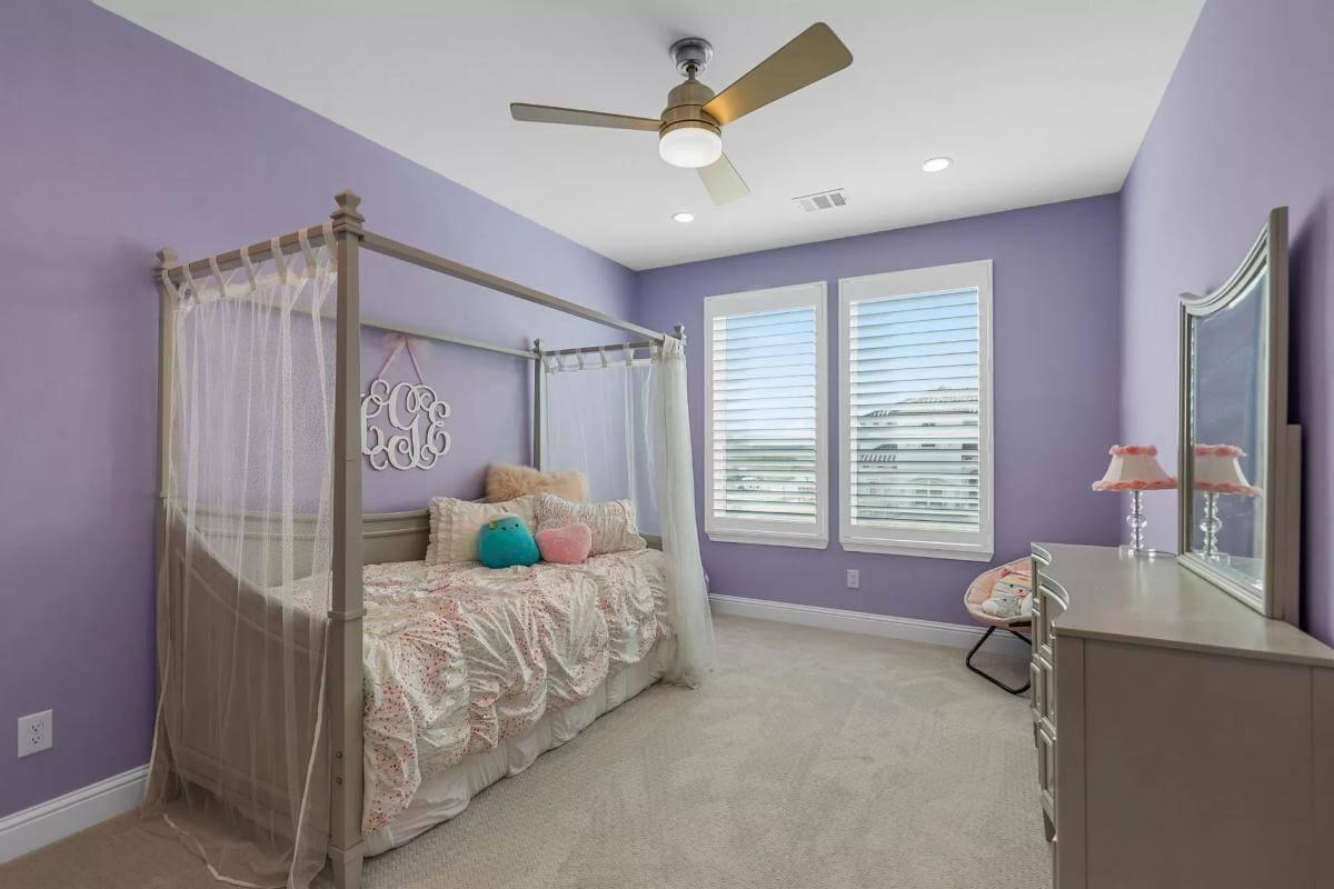 Check Out This Charming Lavender Bedroom with a Canopy Bed