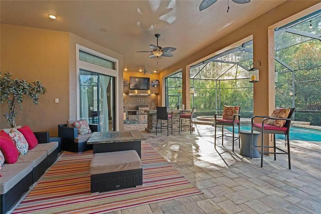 Relax in This Poolside Patio with Open-Air Grilling