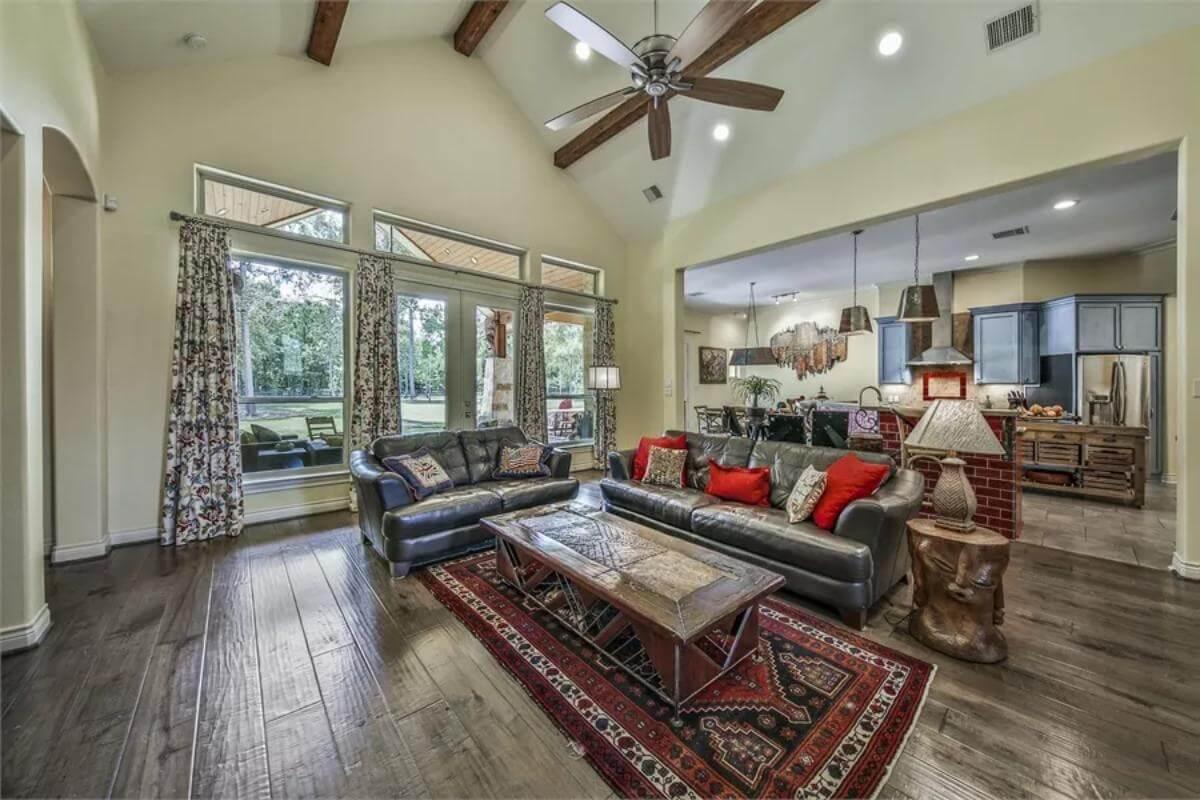 Step Inside This Warm Living Room with High Ceilings and Exposed Beams