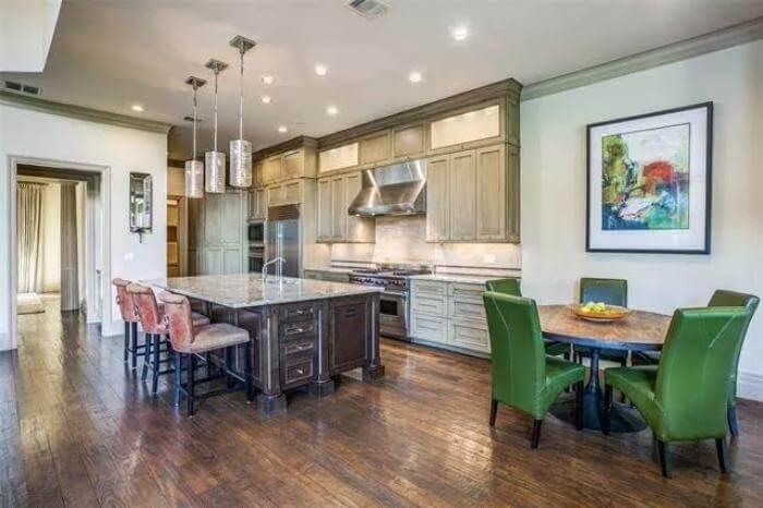 Check Out This Gourmet Kitchen with Sleek Pendant Lighting and a Charming Breakfast Nook