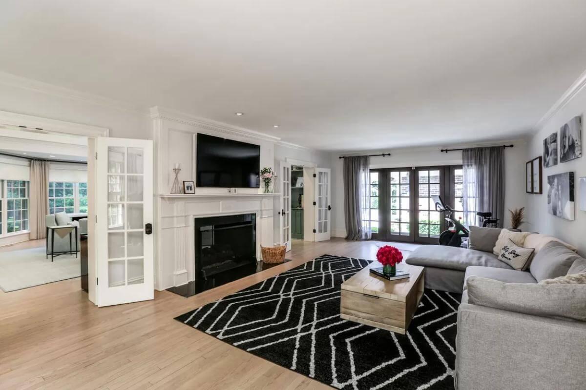 Elegant Family Room Featuring French Doors and a Bold Geometric Rug