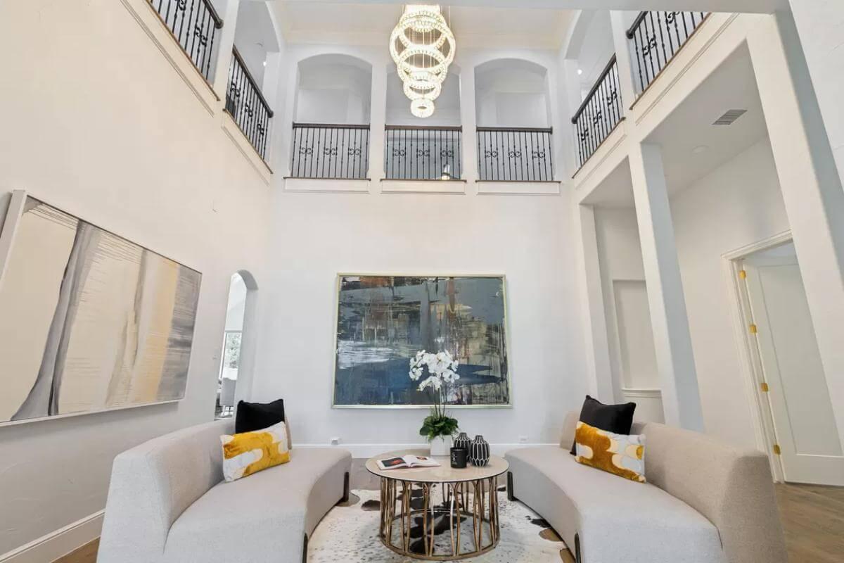 Striking Double-Height Living Room with Elegant Lighting and Art