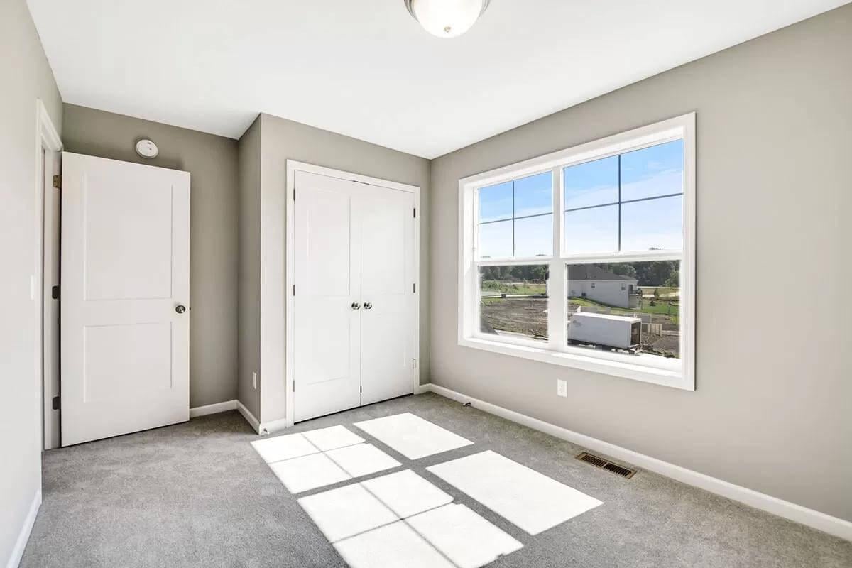 Simple Spare Room with Large Window Inviting Natural Light