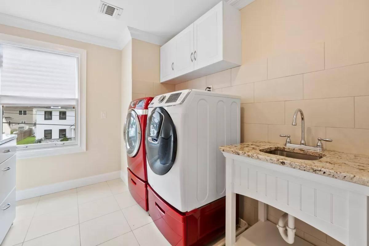 Laundry Room with a Pop of Color from Bold Red Appliances