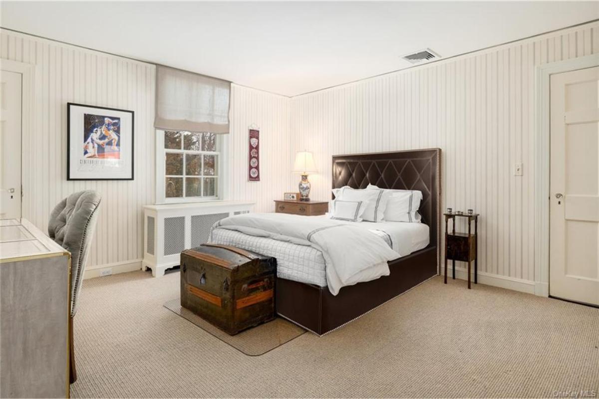Traditional Bedroom with a Leather Headboard and Vintage Trunk