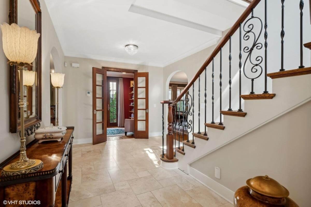 Inviting Foyer with Elegant Ironwork on the Staircase