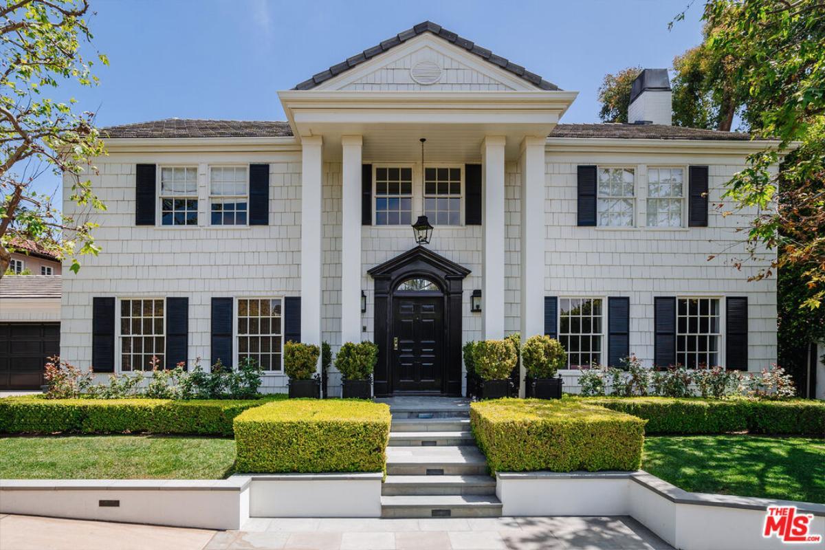 Colonial Symmetry with Striking Black Accents and Pillared Entrance