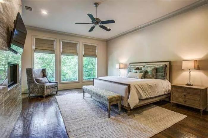 Serene Bedroom with Floor-to-Ceiling Windows and a Cozy Fireplace
