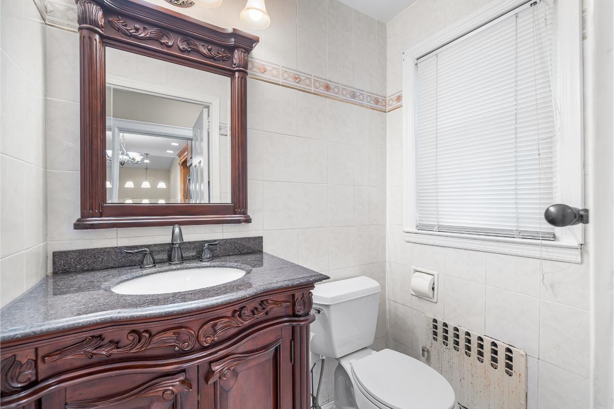 Elegant Bathroom with a Dark Wood Vanity and Ornate Detailing